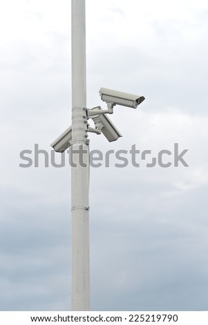 Security CCTV cameras mounted on the post for street surveillance.