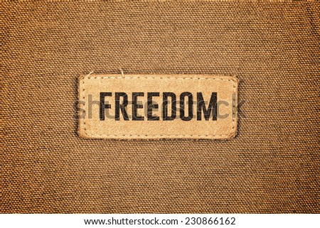 Freedom Leather Label Tag on cotton material texture background.