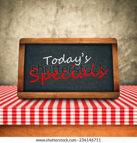 Today\'s Special Title in white chalk on Restaurant Blackboard. Food and Nutrition background.