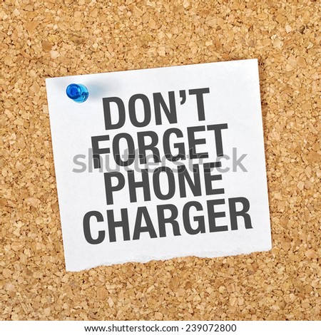 Don't Forget Phone Charger Message on Reminder Note Pinned to a Cork Memory Bulletin Board.