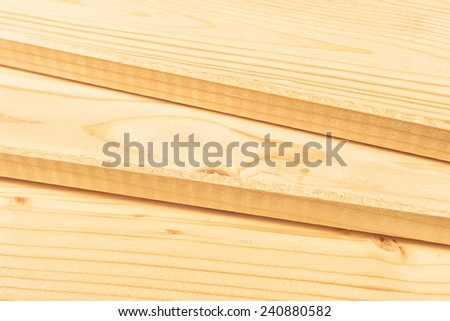 Pine planks stacked and ready for some carpentry job or woodworks. Close up with selective focus and shallow depth of field.