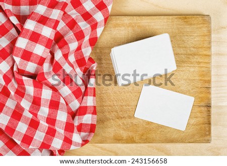 Restaurant Cook\'s Blank Business Cards Template as Copy Space on Wooden Chop Board., top view