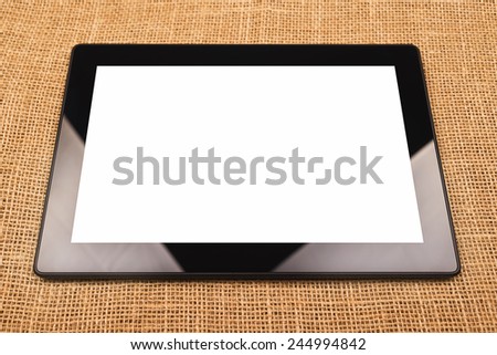 Digital Tablet Computer with Blank White Screen as Copy Space on Office Desktop.