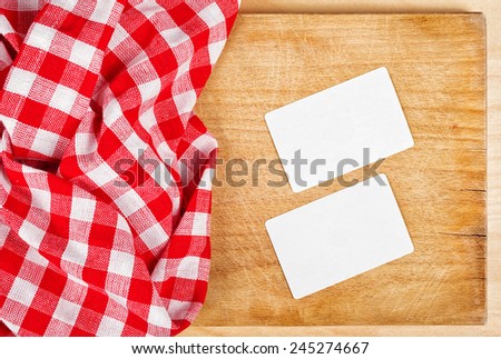 Restaurant Cook\'s Blank Business Cards Template as Copy Space on Wooden Chop Board.