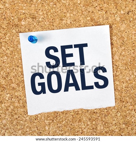 Set Goals Motivational Reminder Note Pinned to a Cork Memory Bulletin Board.