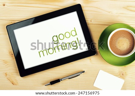 Top View of Good Morning Message on Tablet Computer Screen on Office Table.