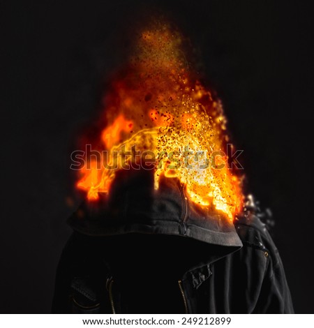 Head on Fire, faceless unknown and unrecognizable man wearing hood on fire.