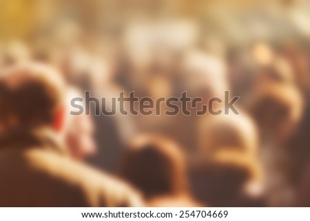 Crowd of People Walking On the Street in Bokeh, unrecognizable group of men and women as blur urban background.