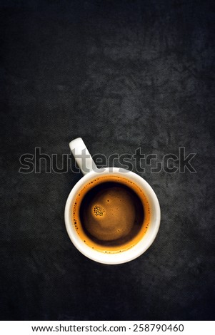 Top View of a Cup of Hot Black Coffee, White Ceramics Mug on Grunge Gray Table Cloth as Copy Space.