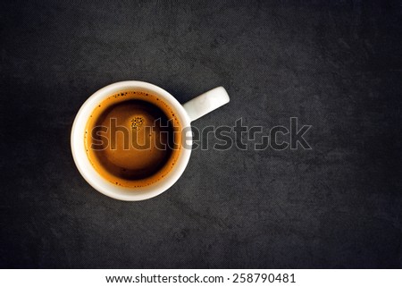 Top View of a Cup of Hot Black Coffee, White Ceramics Mug on Grunge Gray Table Cloth as Copy Space