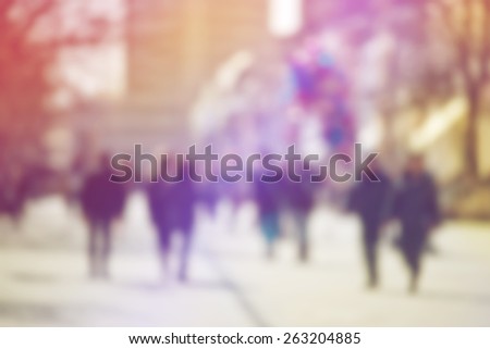 Crowd of People Walking On the Street in Bokeh, unrecognizable group of men and women as blur urban background
