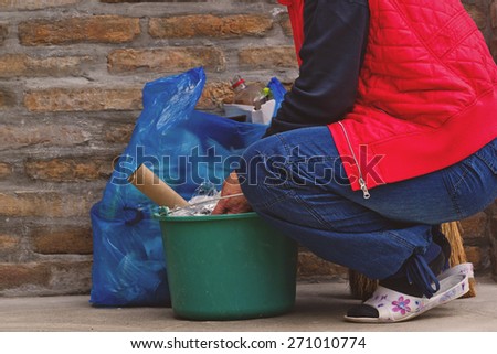 Woman Putting Garbage in Trash Can and Plastic Litter Bag after Cleaning the Outdoor Space