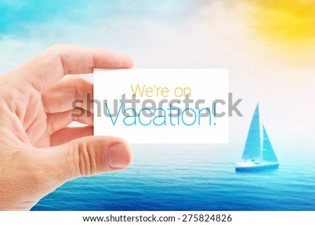 We Are on Vacation Message on Visiting Card for Summer Holiday Season, Sailboat at Sea in Background.