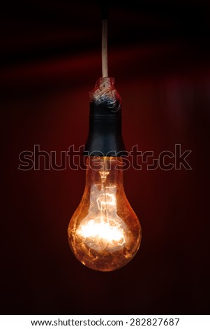 Vintage Light Bulb Shining on Red Background