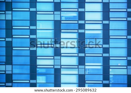 Modern Business Office Building Windows Repeating Pattern, Blue Glass Facade with Geometric Lines, Sunlight Reflecting