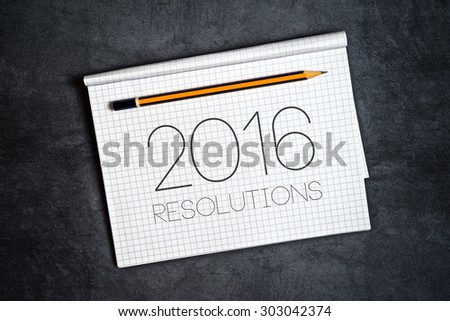 2016, New Year Resolutions Concept with Pencil and Notebook for Writing Goals and Aspiration in Following Year
