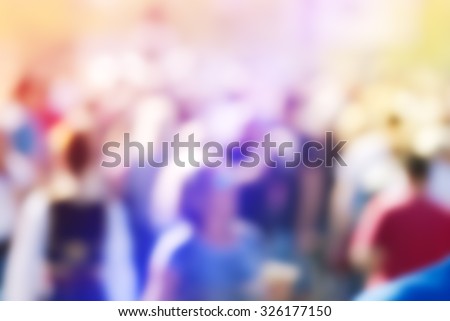 Abstract blur audience crowd of people at public outdoors place or gathering, social event background, vivid colors, defocus image.