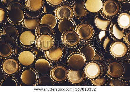 Beer bottle caps heap, unbranded metallic caps as pattern background.