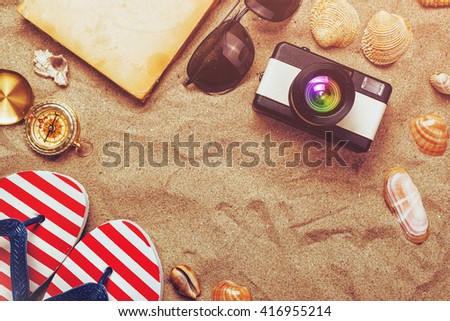 Summer holiday vacation accessories on beach sand, summertime lifestyle objects in flat lay top view arrangement.