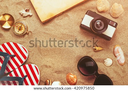 Beach ready, summer holiday vacation accessories in sand, objects in flat lay top view arrangement.