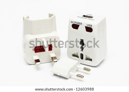 An disassembled universal plug adapter on white background