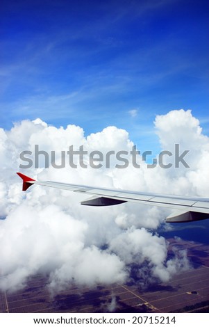 Aerial view of cloudy sky from airplane window.