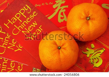 Two mandarin orange put on red packets.