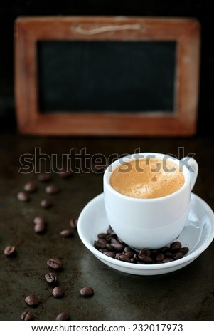Coffee cup and coffee beans with blank chalk board