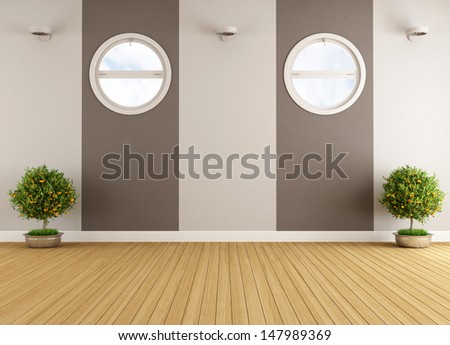 Empty beige and brown interior with two round windows