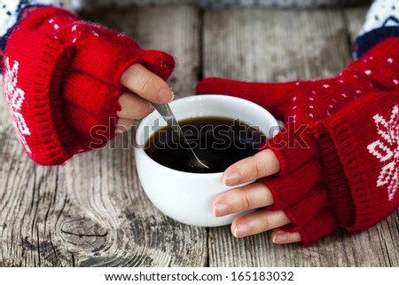 Hands With Gloves Holding Cup Of Coffee