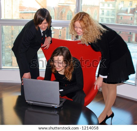 Three woman checking emails