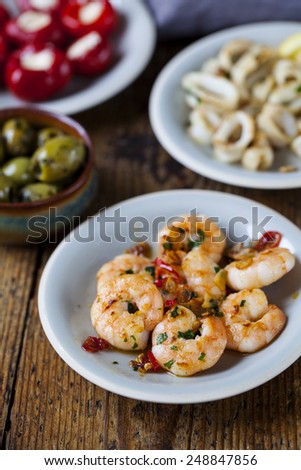 Selection of tapas dishes: prawns, squid, stuffed peppers