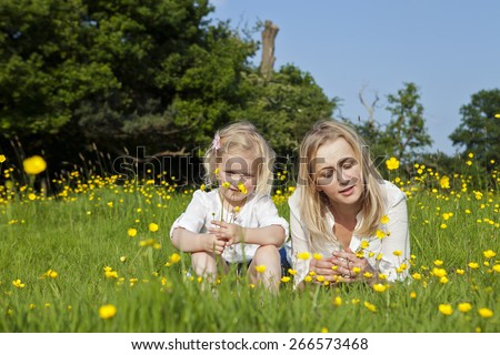 Mum with young daughter in the park on sunny summer day