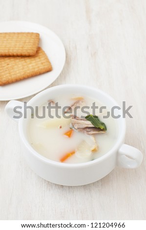 milk soup and crackers on a table