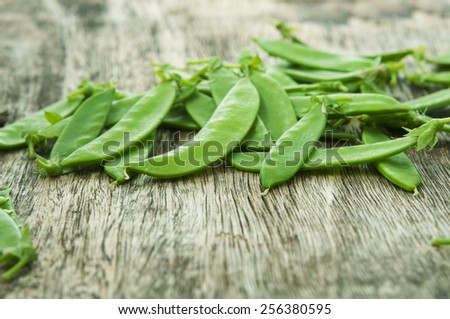 pods of green pea on a table, dof