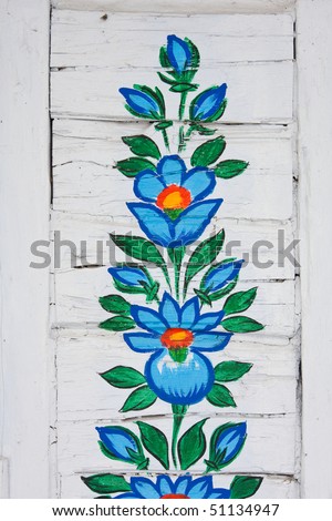 Old white plank with painted flowers
