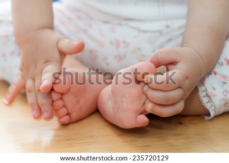 One year old old baby hands and feet closeup