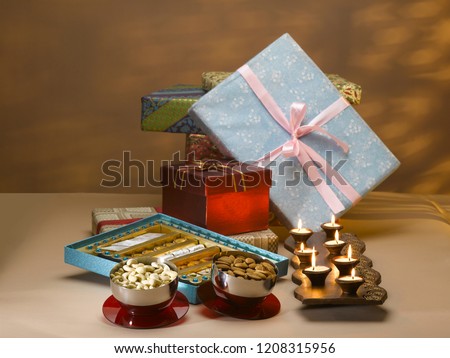 STILL LIFE OF GIFT BOXES, SWEETS, DRY FRUIT BOX, NUTS AND DIYAS