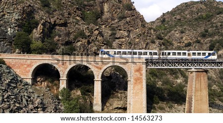 Train on the bridge through a precipice, Corsica, France