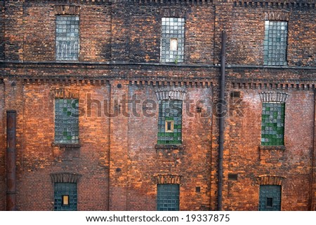 Red brick wall with mosaic windows. Old factory in Saint Petersburg (\'Red Triangle\')