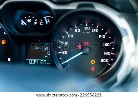 Speedometer in parked car, with LCD display of odometer and trip calculator, and fuel gauge empty