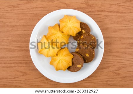 Chocolate cookies and Butter cookies on disc on wooden background , breakfast
