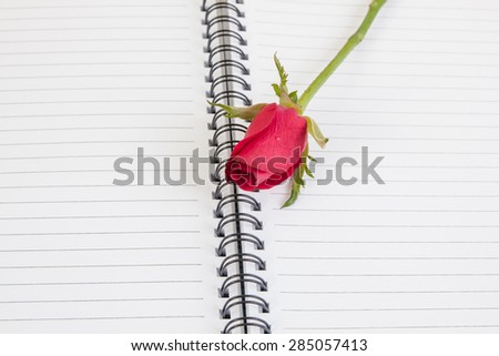 Red rose flower and Notepad book