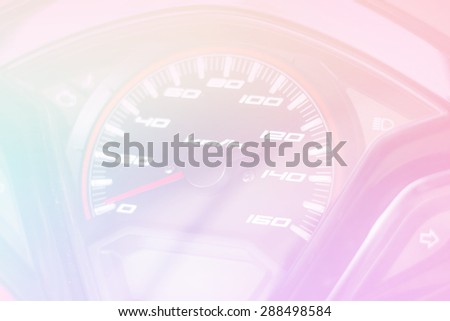 Soft colorful filter for background - Speedometer in parked car, with LCD display of odometer and trip calculator, and fuel gauge empty