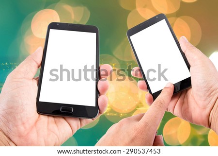Man hand hold blank touch screen smart phone on abstract blurred bokeh of city night light background.