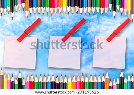 Paper color and wood clip note on blue sky background.