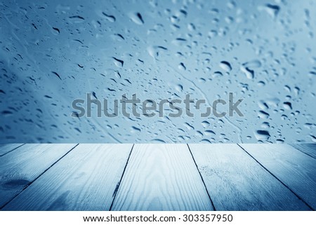 Blue filter - Abstract rain drops on a window or water drops on grass and wood background
