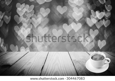 Abstract black and white bokeh of light and coffee cup and wood background