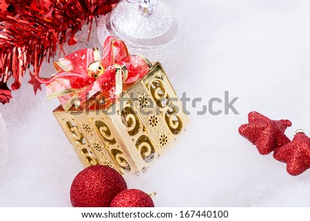 Golden gift box with bow with red Christmas decoration items