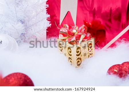 Golden gift box with bow and red gift box with snow Christmas tree and red theme decoration